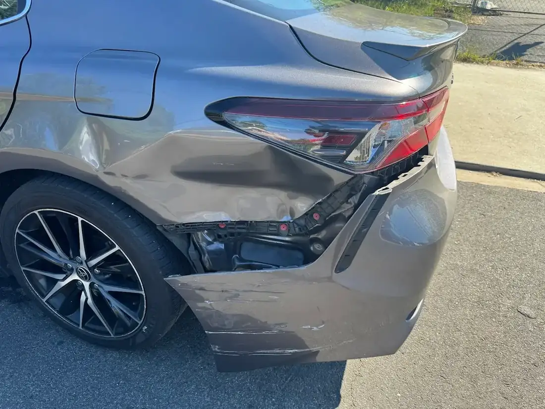 Rear quarter panel and bumper damage before repair